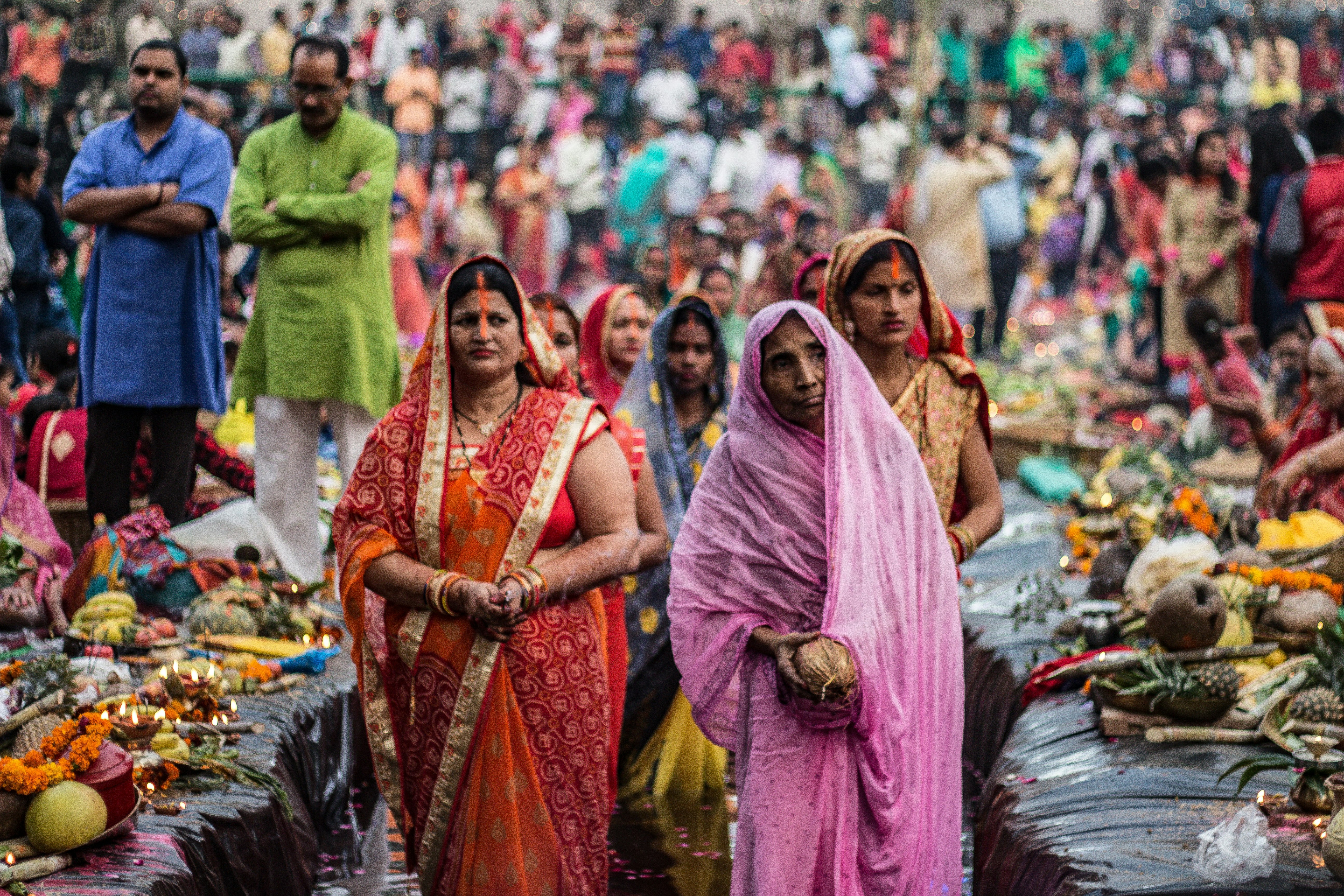 woman in pink and brown hijab standing on street during daytime